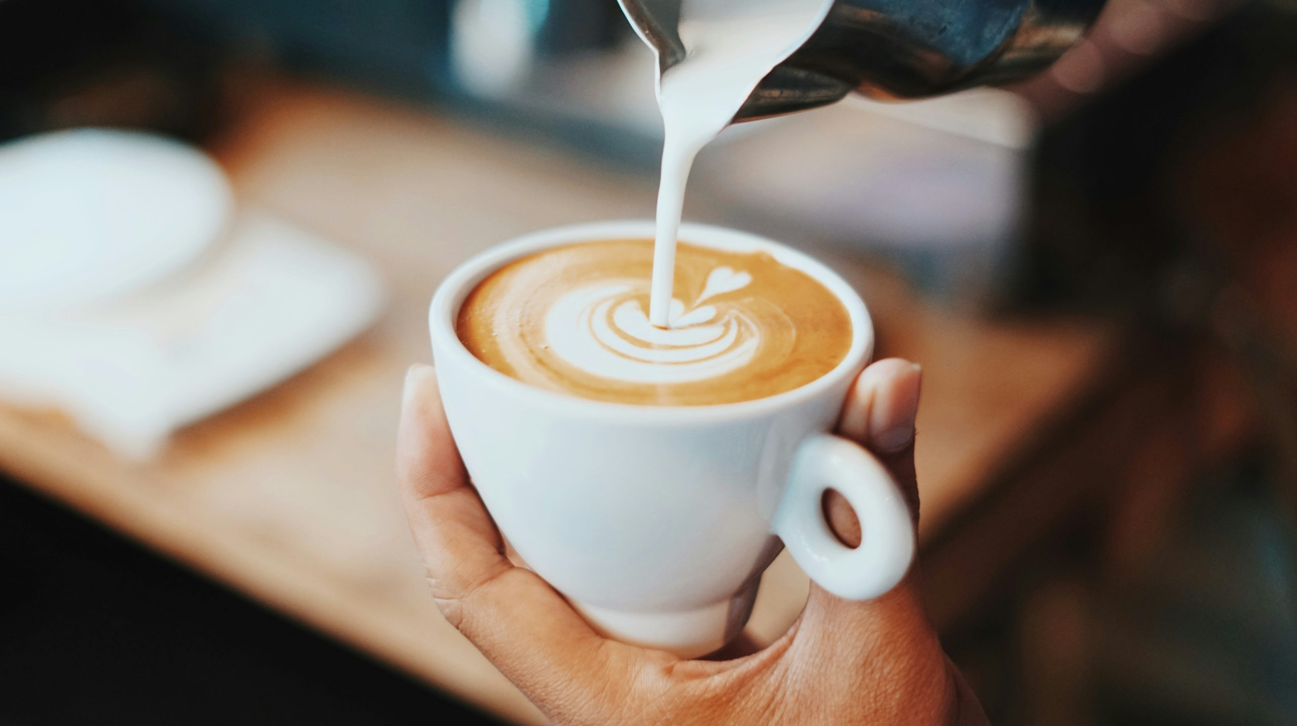Latte art vertiendo leche
